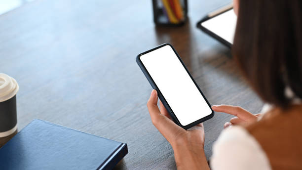istock Close up view of young female office worker using smart phone in office. 1304654240