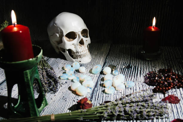 istock Wooden table with occult attributes, top view. Rune stones, candles. 1304655963