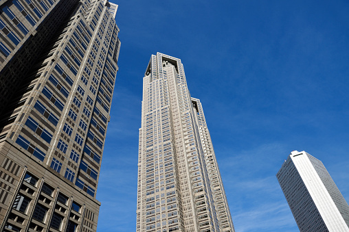 Low angle view of skyscrapers against blue sky with copy space.