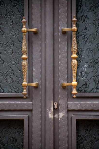 Front door detail, retro style carved handles.  Galicia, Spain.
