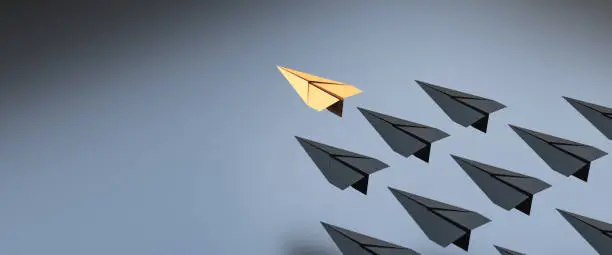 Photo of Leadership concept, yellow leader plane leading black planes, on black background with empty copy space on left side