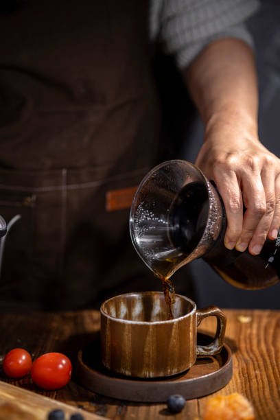 istock hand pouring coffee to coffee cup 1304660266