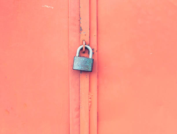 istock Rough surface of  locked red iron door. Grungy metal surface. 1304662489