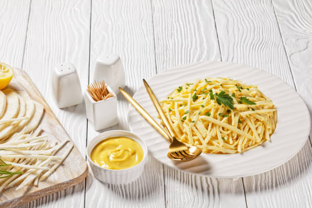 istock Celery Root Remoulade, classic bistro salad julienned celery root melds with a Dijon mustard dressing on a white plate 1304662858