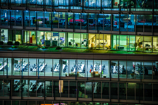 Close up of highly detailed and illuminated modern office building during night hours in London City, UK, photographed on Canon EOS R full frame system.