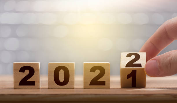 istock Fingers turning the block from 2021 to 2022. 1304668563