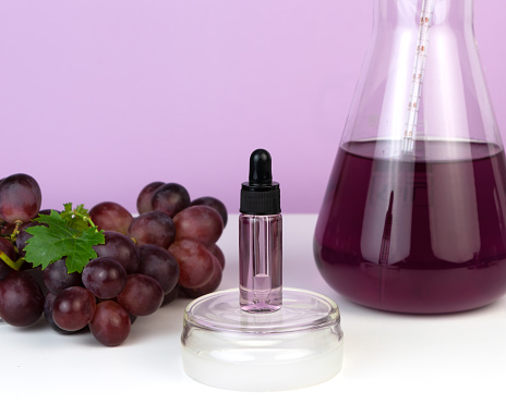Organic bio grape cosmetics. Extract, grape seed oils, serum. Grapes are a powerful antioxidant. Abstract cosmetic laboratory.