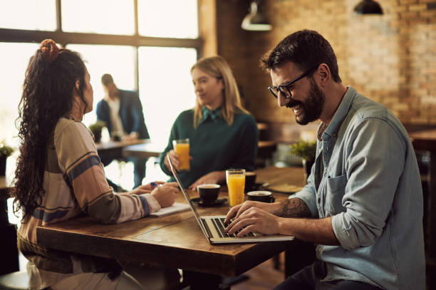 istock Happy man surfing the net on laptop in a cafe. 1304670771