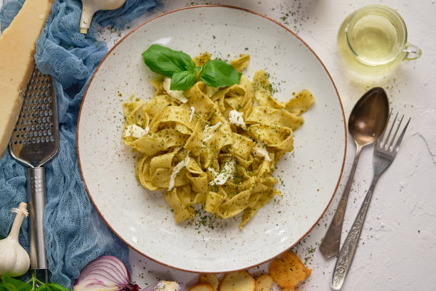 istock Tasty tagliatelle pasta with basil and green pesto 1304670802