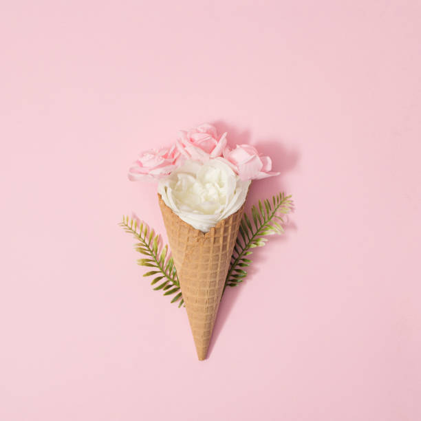istock Pink and white roses in brown cornet. Pink background. Minimal. Flat lay. 1304670892