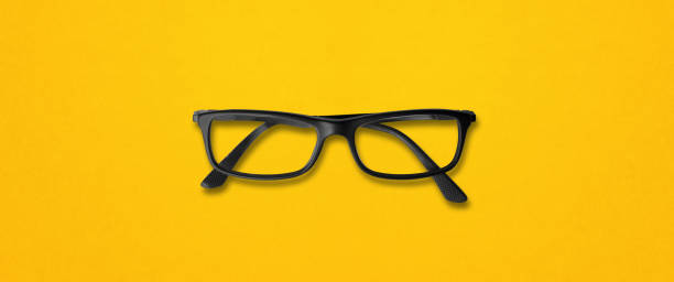 istock Black glasses isolated on yellow banner 1304672060