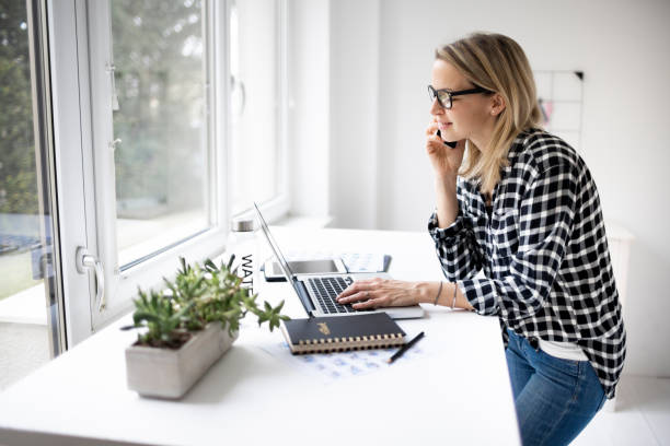 istock Businesswoman working at ergonomic standing workstation. 1304673813