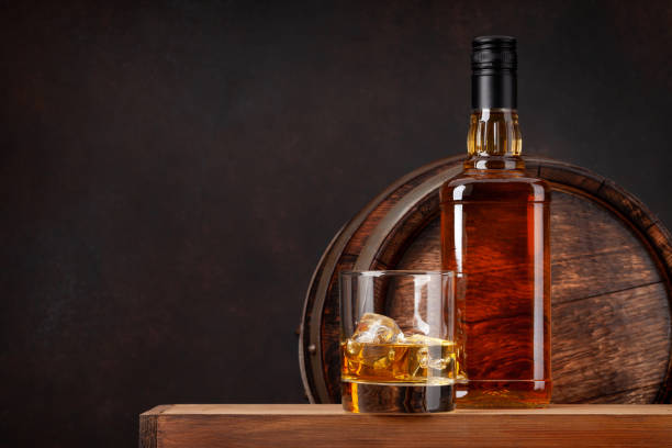 istock Scotch whiskey bottle, glass and old barrel 1304677303