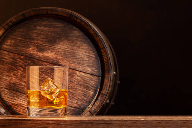 istock Scotch whiskey glass and old barrel 1304677354