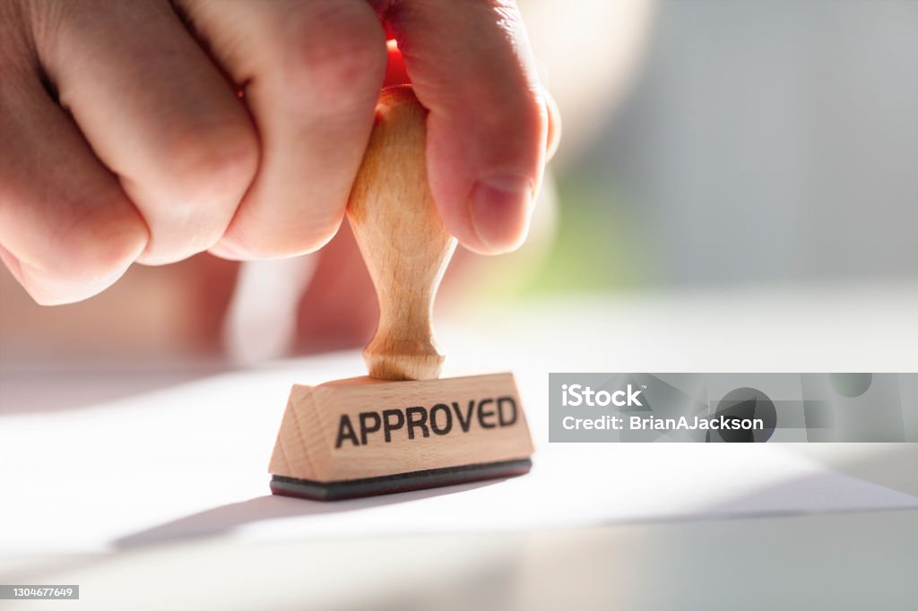 Businessman stamping approved stamp on document in meeting Businessman or notary public stamping approved stamp on document in meeting Endorsing Stock Photo