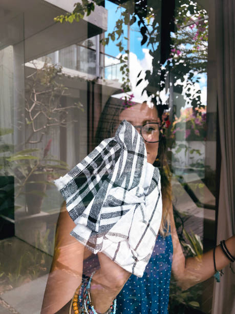 istock Woman holding rag for cleaning the window. 1304678776