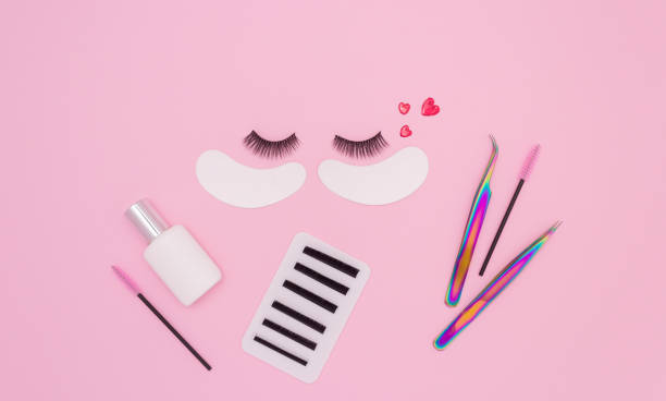 istock Tools and patches for eyelash extensions and artificial eyelashes on a pink background. Tools for the lashmaker. The view from the top. 1304678992