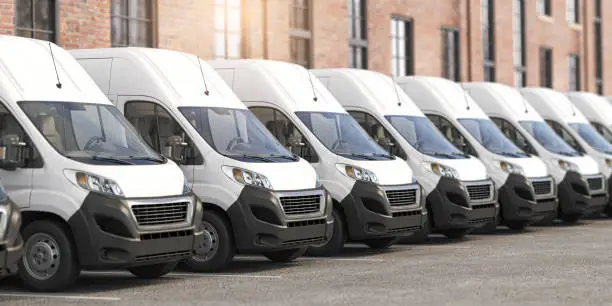 Photo of Delivery vans in a row.  Express delivery and shipment service concept.
