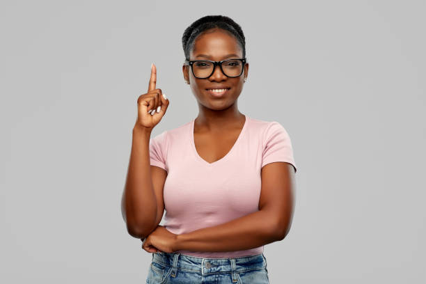 african american woman in glasses with finger up - finger raised imagens e fotografias de stock