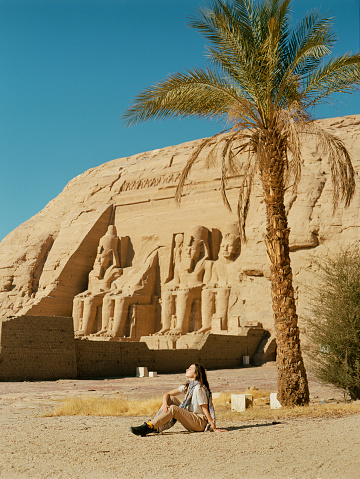 Young Caucasian woman  looking at  Abu Simbel temples