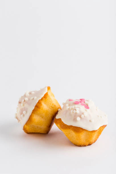 istock Two muffins with chocolate glazed and confit on a white background, isolated. 1304685334