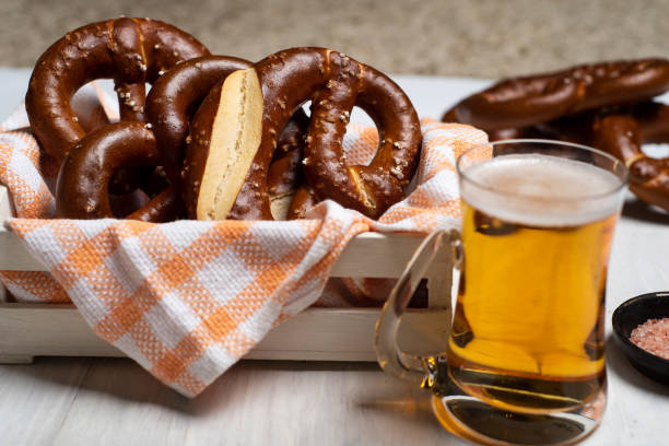 istock German bread pretzels with beer on a wooden table top view 1304686139
