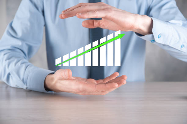 istock Businessman man holding a graph with positive profits growth. plan graph growth and increase of chart positive indicators in his business.more profitable and growing 1304686361