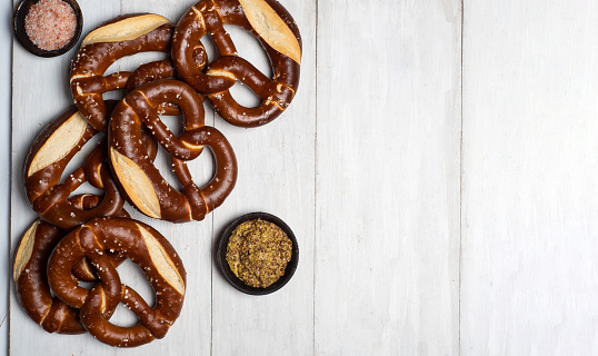Bunch of soft German bread pretzel on a wooden table top view