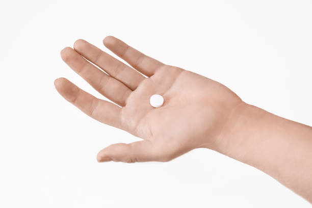 istock Close up of a med pill on hand 1304686410