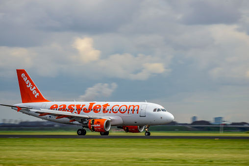 EasyJet Airbus A319-111 landing at Amsterdam Airport Schiphol. The G-EZSM is part of the fleet of EasyJet, the British low-cost airline carrier easyJet.