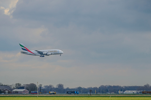 Emirates Airline Airbus A380 approaching Schiphol Amsterdam Airport in The Netherlands. The A380 is flying between Amsterdam and Dubai.