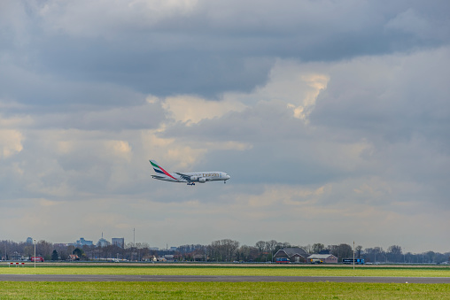 Emirates Airline Airbus A380 approaching Schiphol Amsterdam Airport in The Netherlands. The A380 is flying between Amsterdam and Dubai.