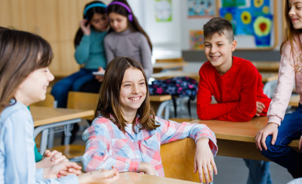 istock Children sitting and talking in the classroom 1304686774