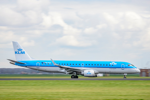 KLM Embraer ERJ-175 Cityhopper landig at Schiphol airport. The KLM Cityhopper airplanes connect various cities in Europe to Amsterdam Schiphol Airport.