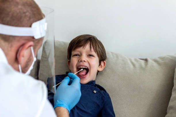 istock Pediatrician using a swab to take a sample from a patient's throat. 1304687533