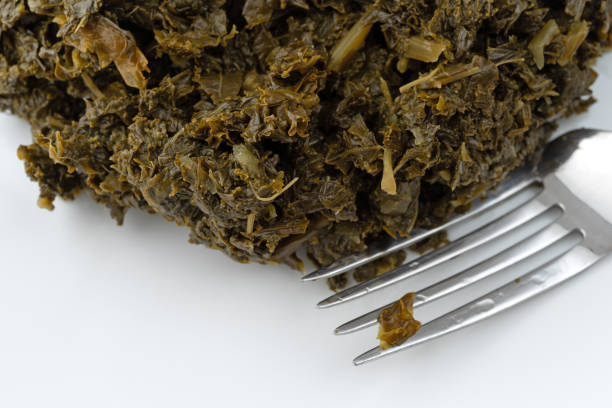 Close view of a portion of chopped kale on a white plate.