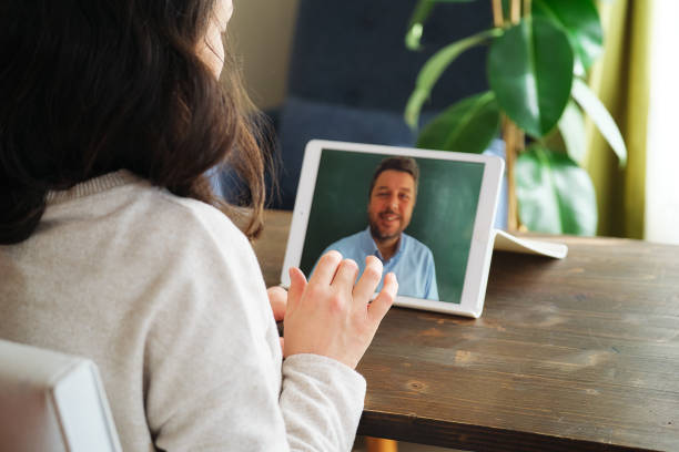 istock Happy family talking within video call on digital tablet 1304688012