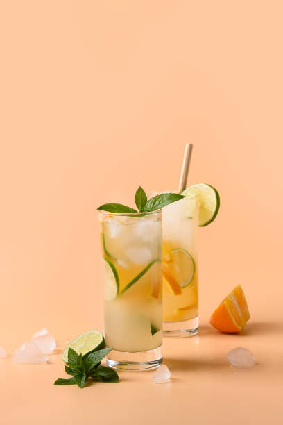 istock Cold and refreshing lemonade or cocktail with orange and lime slice. 1304688722