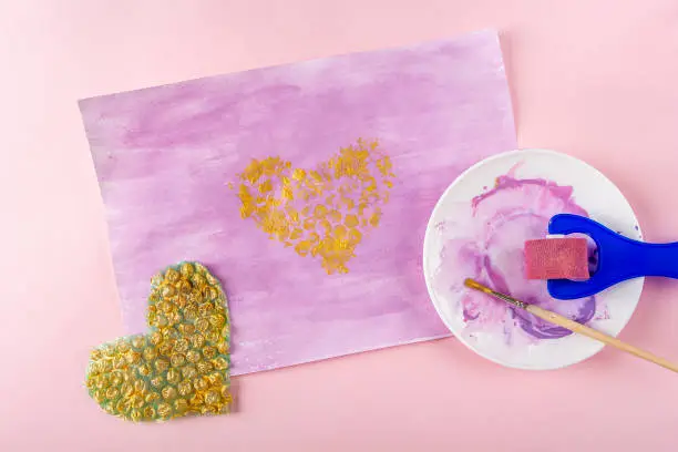 Photo of DIY and kids creativity Step by step instruction: Drawing greeting card non-standard method. Step3 prints heart-shaped bubble wrap on paper. Valentines, womens and mothers day craft