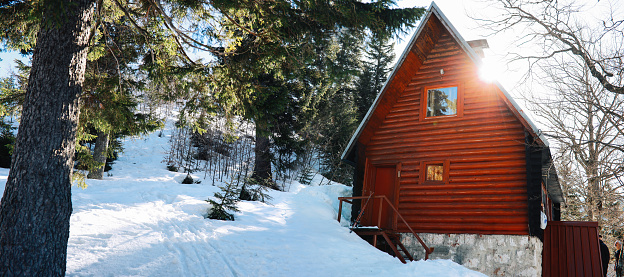 Tourists exploring near a Log Cabin (John Moulton Homestead) on Mormon Row at Jackson Hole in Grand Teton National Park at Teton County, Wyoming