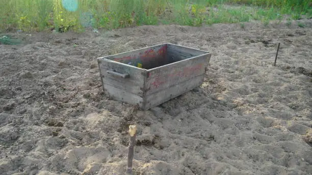 Old wooden Trough to hold animal fodder in a pet farmland. Wooden pot holding in a agriculture farmland. Animal feeding concept.