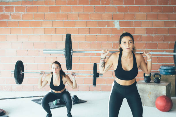 istock Women doing barbell squats 1304691597