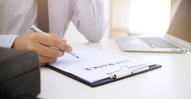 istock Sales manager giving advice application form document, considering mortgage loan offer for car and house insurance. 1304692306