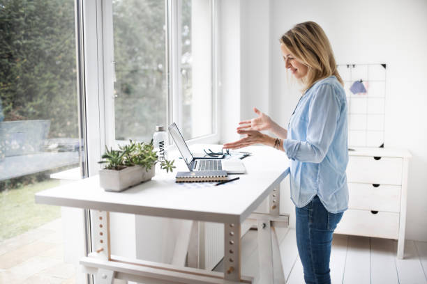 istock Businesswoman working at ergonomic standing desk 1304692989