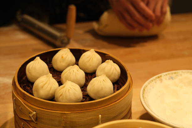 istock making raw steamed buns. Traditional Chinese snack 1304694038