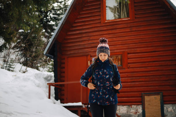 istock Young woman leaving her winter cabin 1304694135