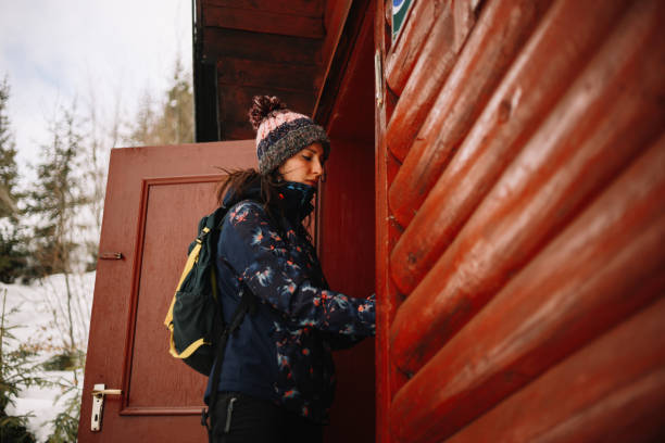 istock Young woman leaving her winter cabin 1304694176