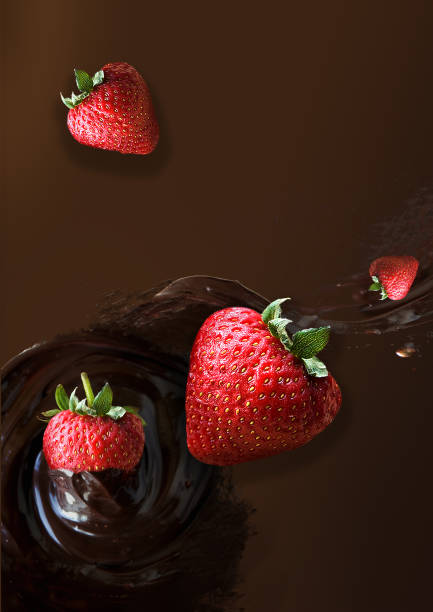 istock Floating Fresh Strawberries with Chocolate Sauce Splash on Background 1304695079
