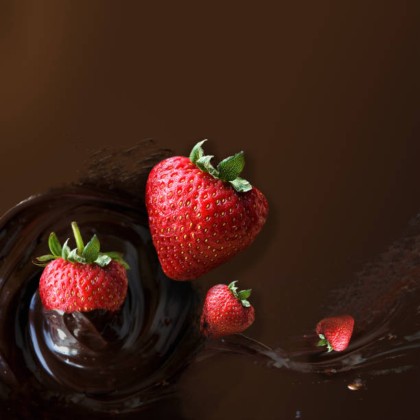istock Fresh Strawberries Dipping in Chocolate Sauce 1304695132