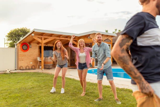 istock Young friends having fun racing by jumping in sacks 1304695594